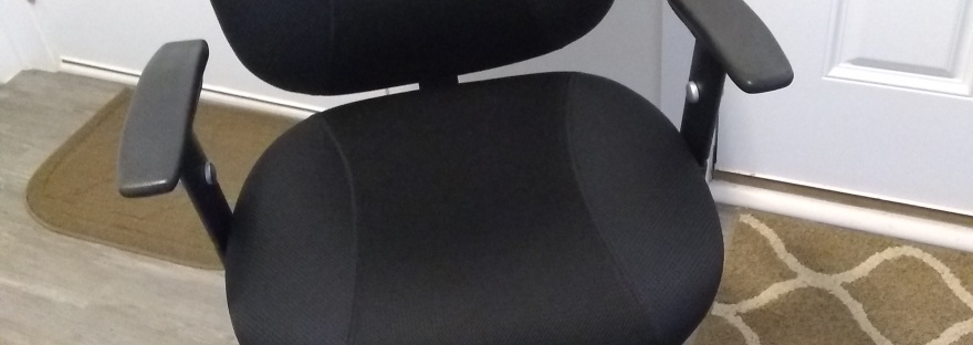 Phot of black office chair with wheels.